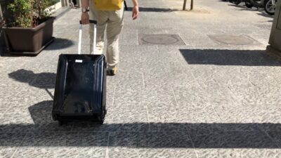石畳の道でスーツケースを引いて歩いているところ
